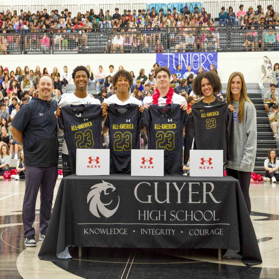 Guyer students and staff pose with jerseys 
